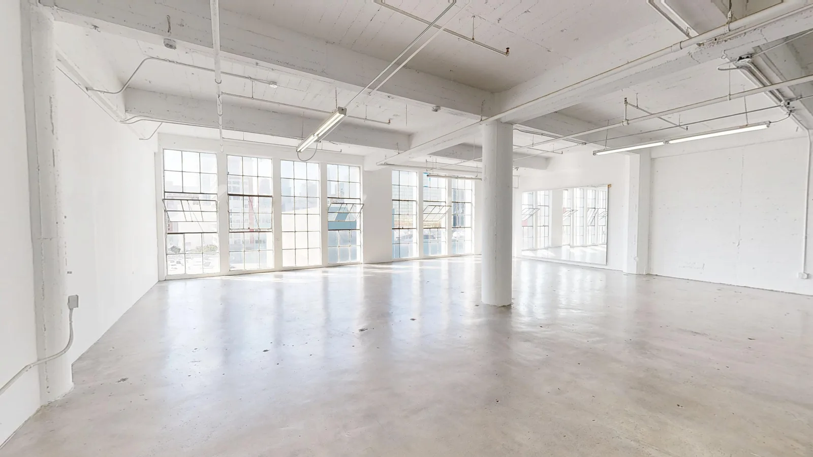 Industrial warehouse and creative space at 1024 Santee Street — white brick, steel windows and open floor