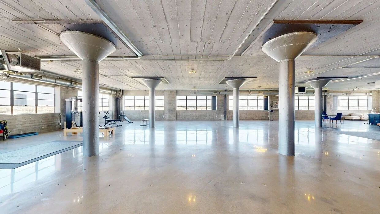 Penthouse Loft at 530 E 8th Street, Suite 600 — polished concrete floors, columns and wraparound windows